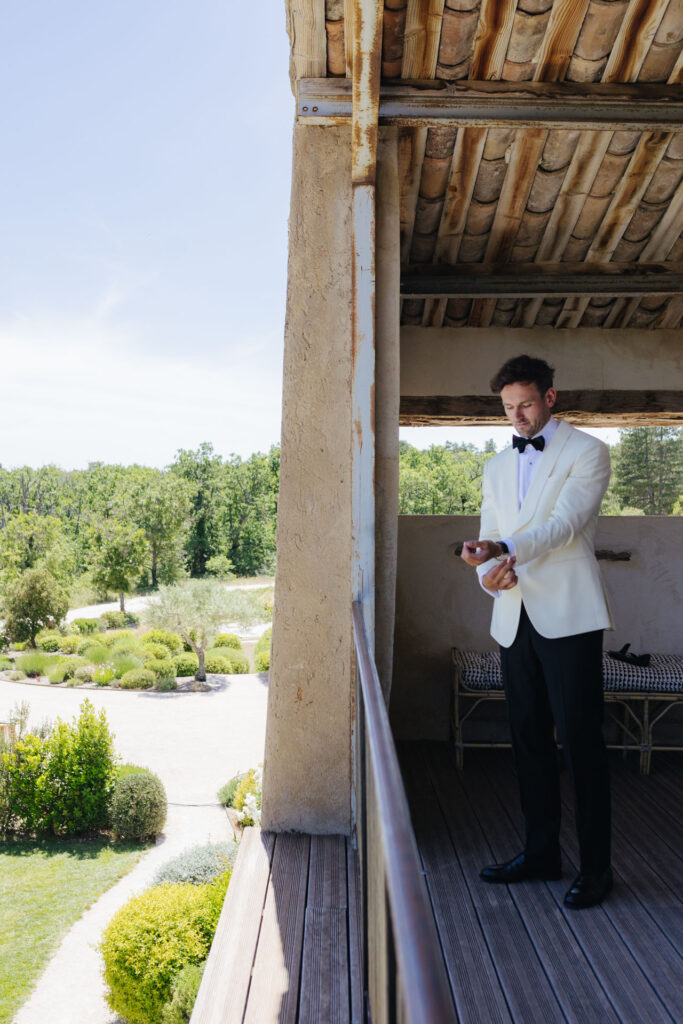 Groom on the balcony overlooking the Provence countryside — Grange de Javon wedding