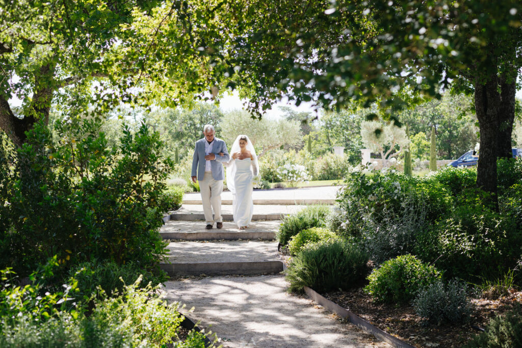 Bride walking down the garden aisle with her father — Grange de Javon wedding