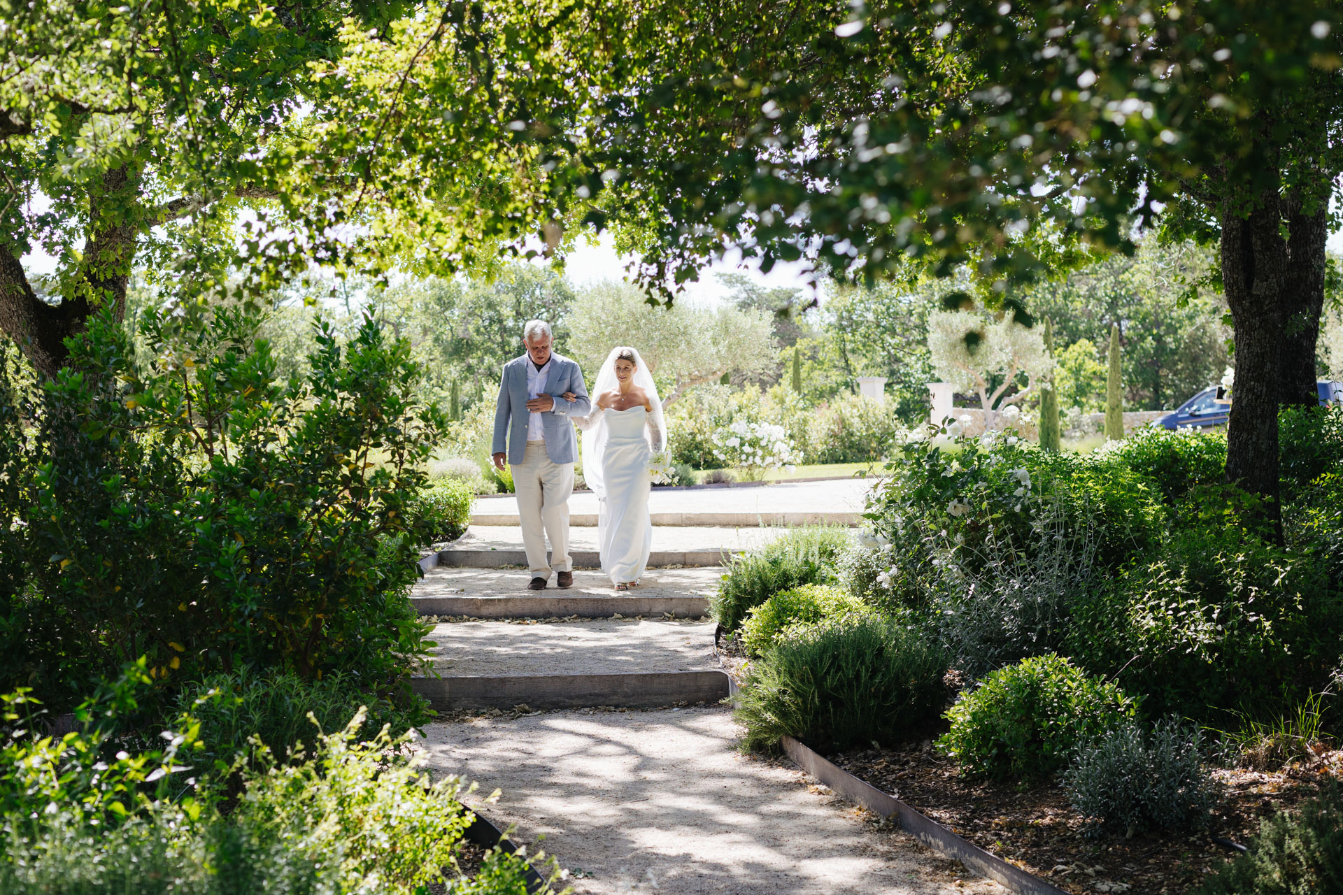 Bride walking down the garden aisle with her father — Grange de Javon wedding