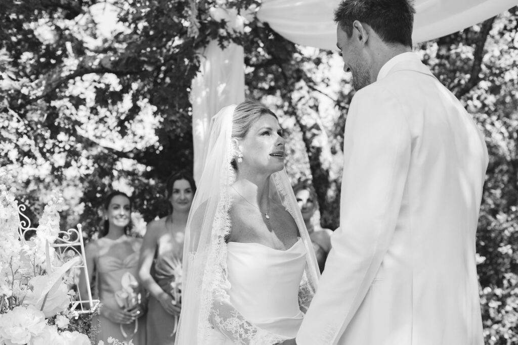 Bride and groom holding hands during the ceremony — Grange de Javon, Provence