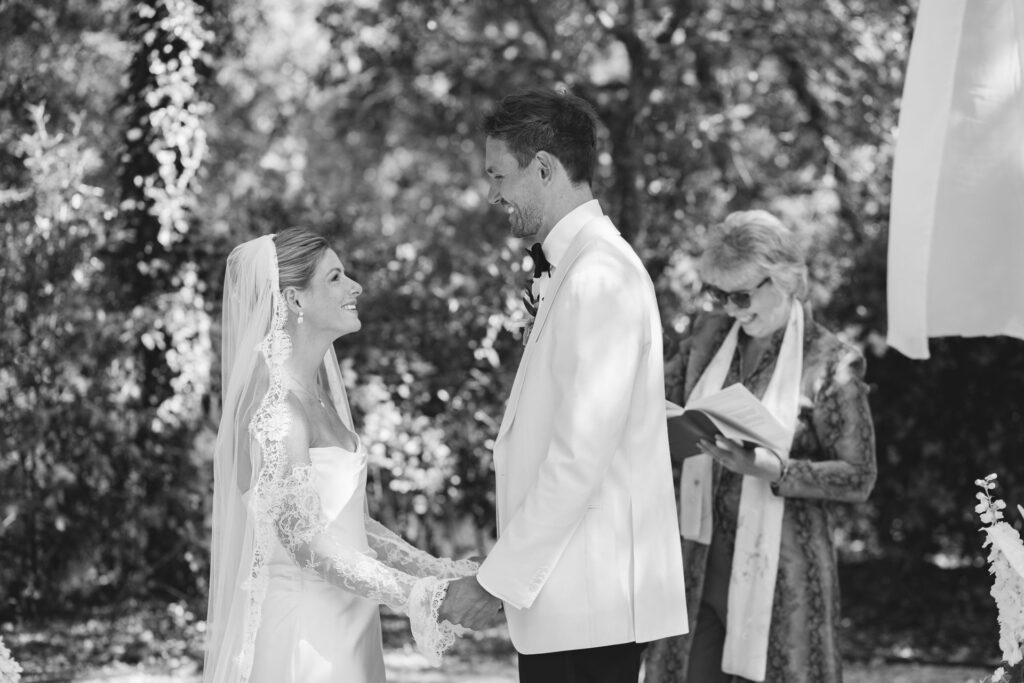 Bride and groom exchanging vows with the officiant — Grange de Javon wedding