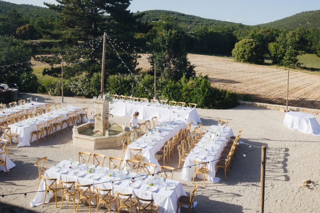 Al fresco reception tables set in a Provence field — Grange de Javon wedding