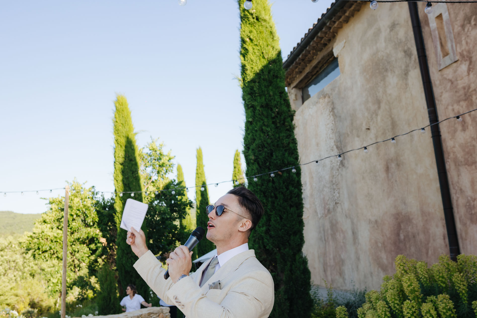 Guest reading a note during the aperitif — Grange de Javon wedding