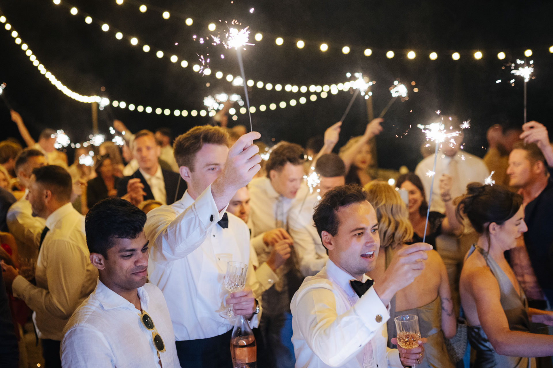 Guests with sparklers on the dance floor — Grange de Javon wedding