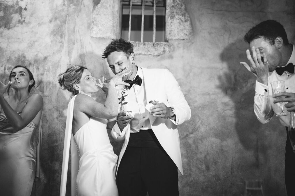 Newlyweds celebrating with guests, black and white — Grange de Javon wedding
