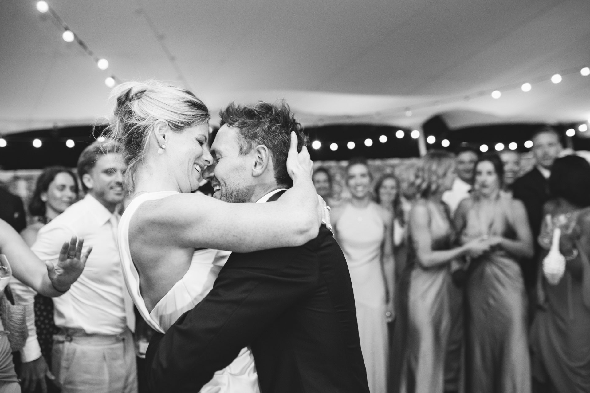 Bride and groom's first dance surrounded by guests — Grange de Javon wedding