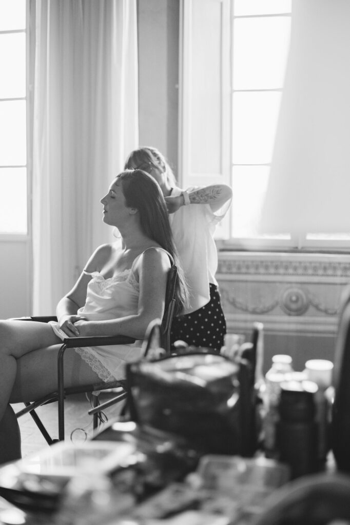 Bride's hair styled during morning preparations, black and white