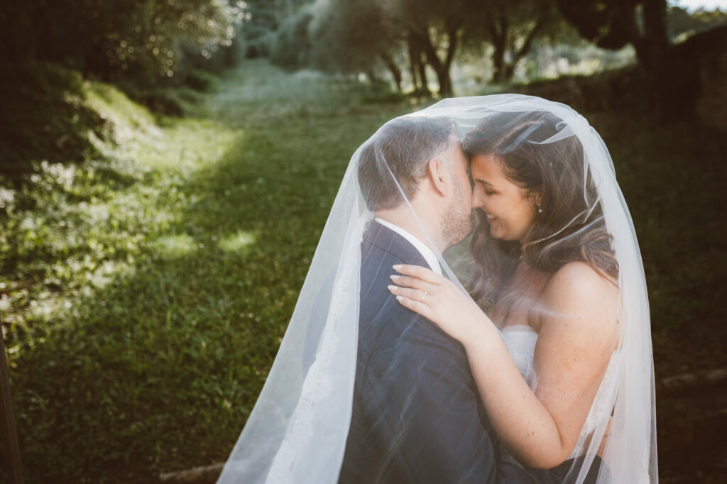 A stolen moment under the veil, foreheads touching