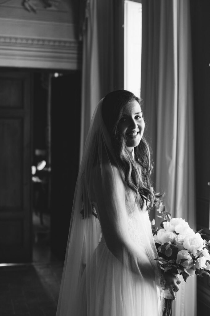 Bride in evening light at the window, black and white