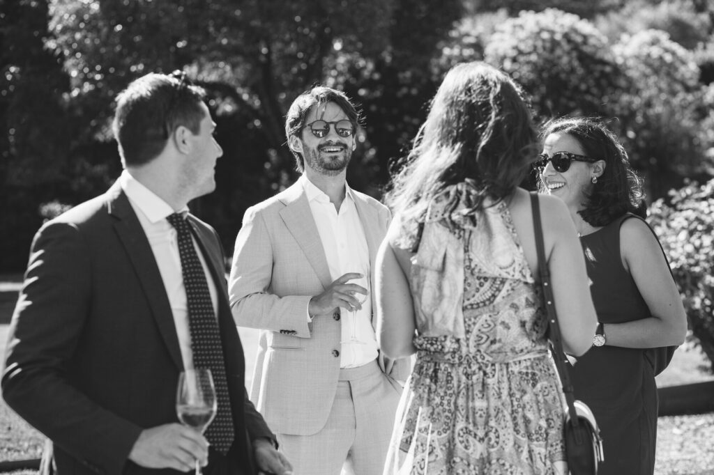 Candid moment among wedding guests, black and white